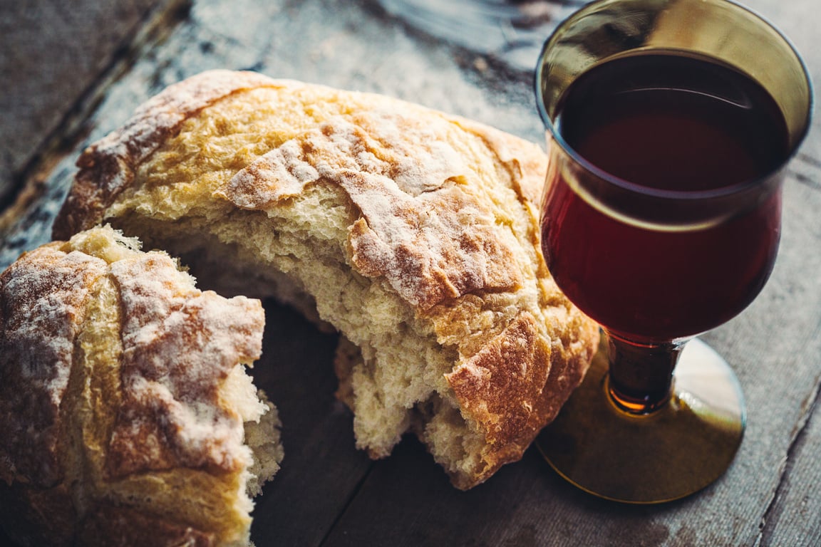 Communion Bread, Wine, and Grapes on Black Background